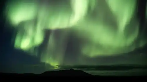 Northern Lights dancing over a mountain